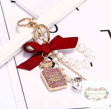 Load image into Gallery viewer, Diamond-Studded Perfume Bottle Keychain Bow Pearl Handmade Pendant Luxury Designer Keychain Charm Keychain
