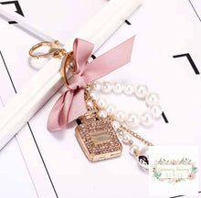 Load image into Gallery viewer, Diamond-Studded Perfume Bottle Keychain Bow Pearl Handmade Pendant Luxury Designer Keychain Charm Keychain
